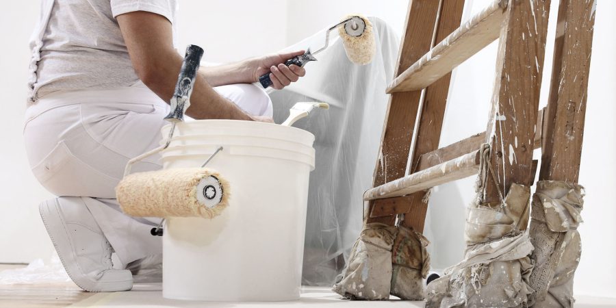 painter man at work with a roller, bucket and scale, bottom view